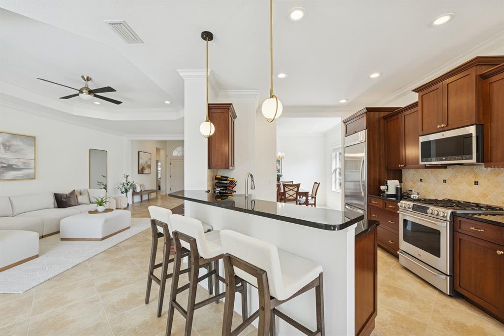 14614 Newtonmore Lane Lakewood Ranch, FL 34202 - Photo 17 of 72 a large kitchen with a table and chairs