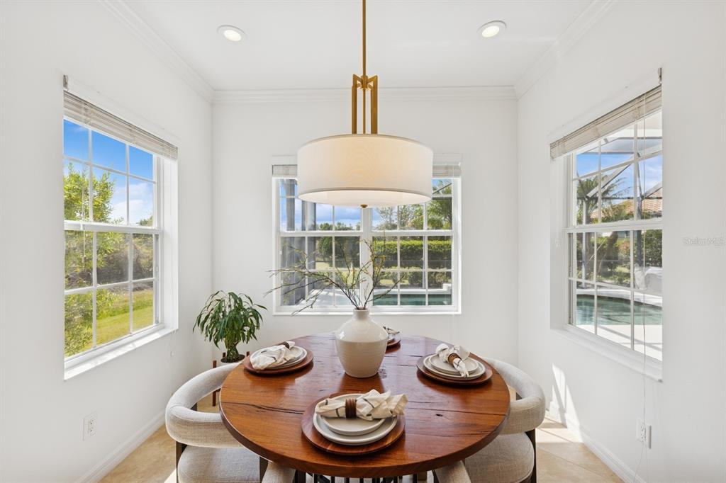 14614 Newtonmore Lane Lakewood Ranch, FL 34202 - Photo 19 of 72 a view of a dining room with furniture window and wooden floor