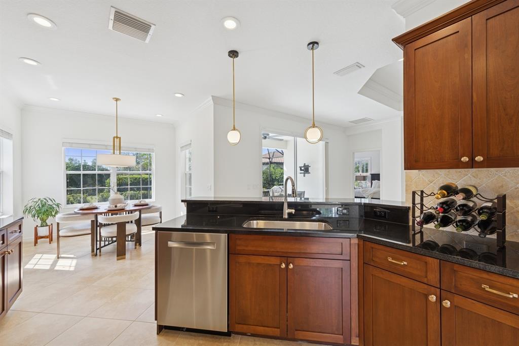 14614 Newtonmore Lane Lakewood Ranch, FL 34202 - Photo 23 of 72 a kitchen with granite countertop a sink a counter space appliances and cabinets