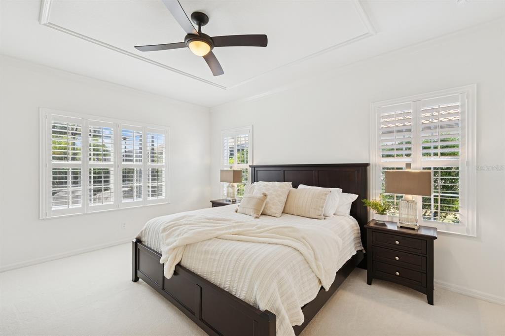 14614 Newtonmore Lane Lakewood Ranch, FL 34202 - Photo 27 of 72 a bedroom with a bed window and a chandelier