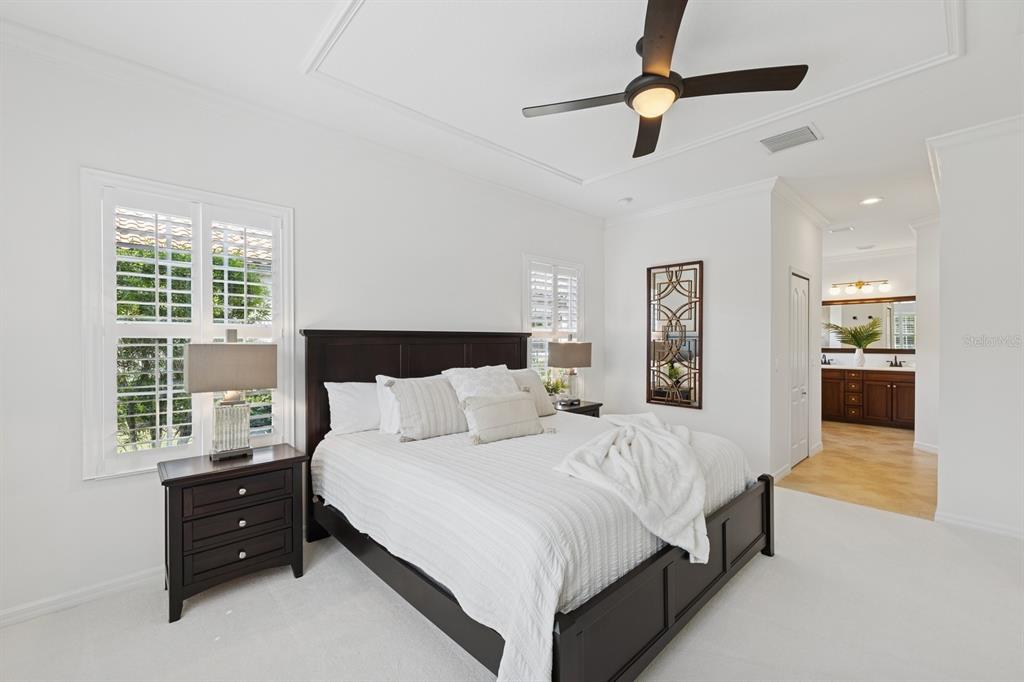 14614 Newtonmore Lane Lakewood Ranch, FL 34202 - Photo 29 of 72 a large bedroom with a bed and a chandelier
