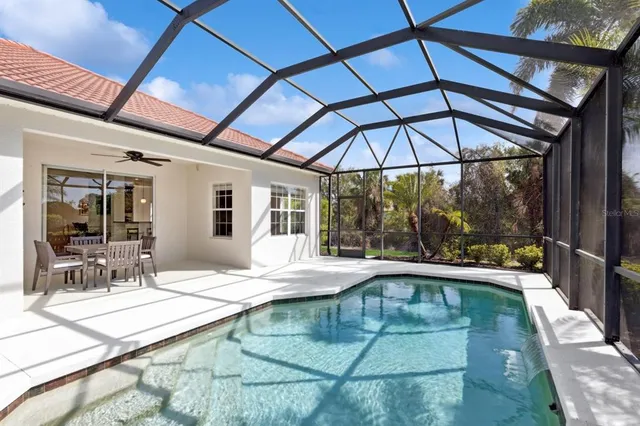 a view of a house with a yard and potted plants