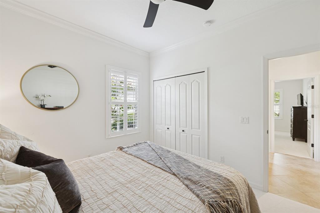 14614 Newtonmore Lane Lakewood Ranch, FL 34202 - Photo 36 of 72 a bedroom with a bed and a chandelier