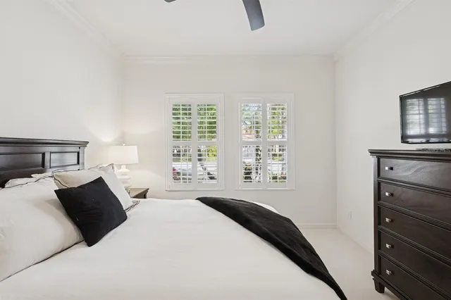 a view of a house with a yard and potted plants