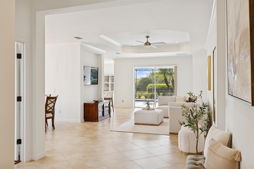 14614 Newtonmore Lane Lakewood Ranch, FL 34202 - Photo 8 of 72 a living room with furniture and a chandelier