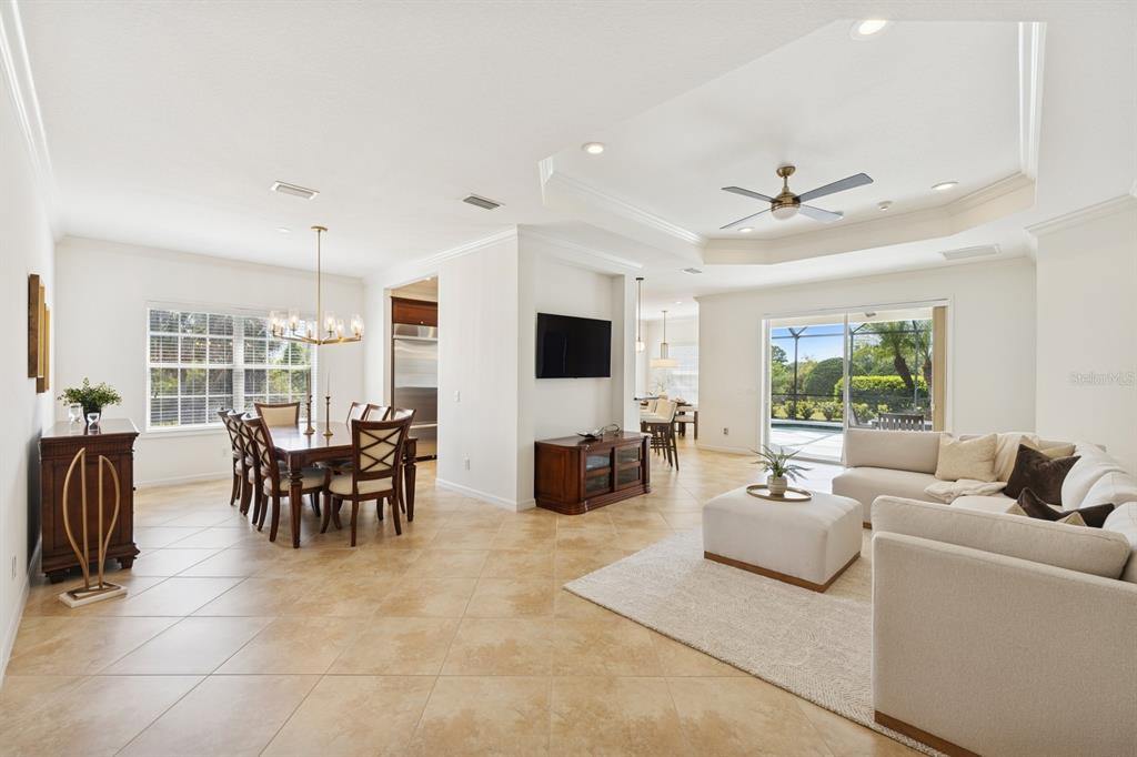14614 Newtonmore Lane Lakewood Ranch, FL 34202 - Photo 9 of 72 a living room with furniture and a flat screen tv