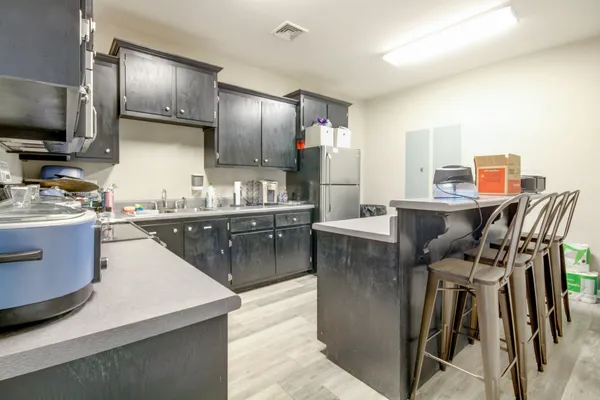 a kitchen with kitchen island stainless steel appliances a sink stove and refrigerator