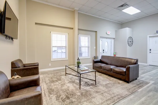 a living room with furniture and a flat screen tv