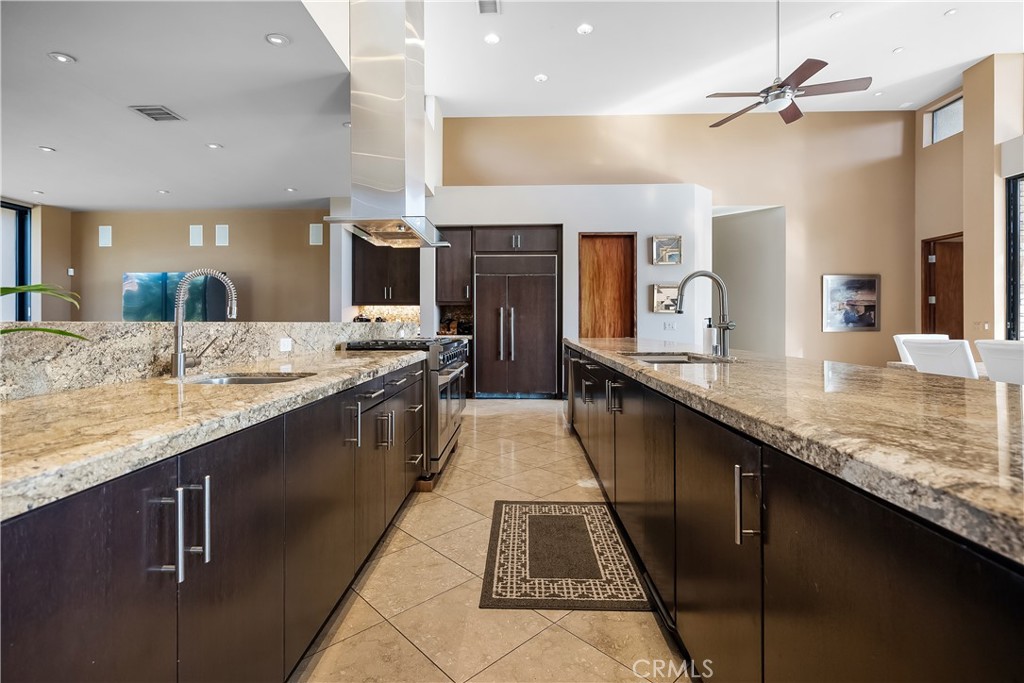 68 Royal St Georges Way Rancho Mirage, CA 92270 - Photo 26 of 75 a large kitchen with granite countertop a sink and cabinets