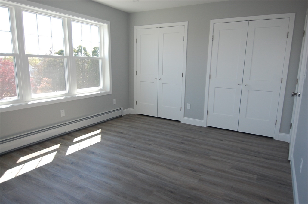 9 Bolton Road, Unit N Dartmouth, MA 02748 - Photo 15 of 19 a view of an empty room with wooden floor and a window