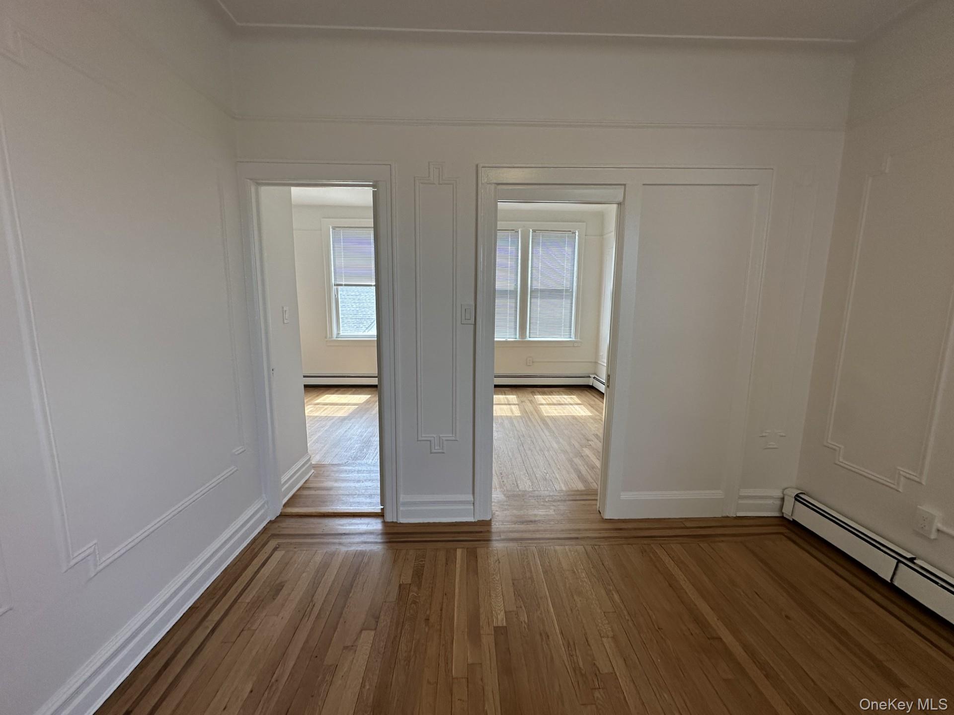 117 Plandome Road, Unit 2R Manhasset, NY 11030 - Photo 9 of 13 Living room featuring hardwood flooring and baseboard heating
