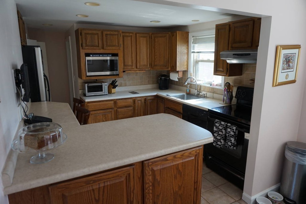 16 Waring Road Natick, MA 01760 - Photo 6 of 12 a kitchen with stainless steel appliances a sink stove and refrigerator