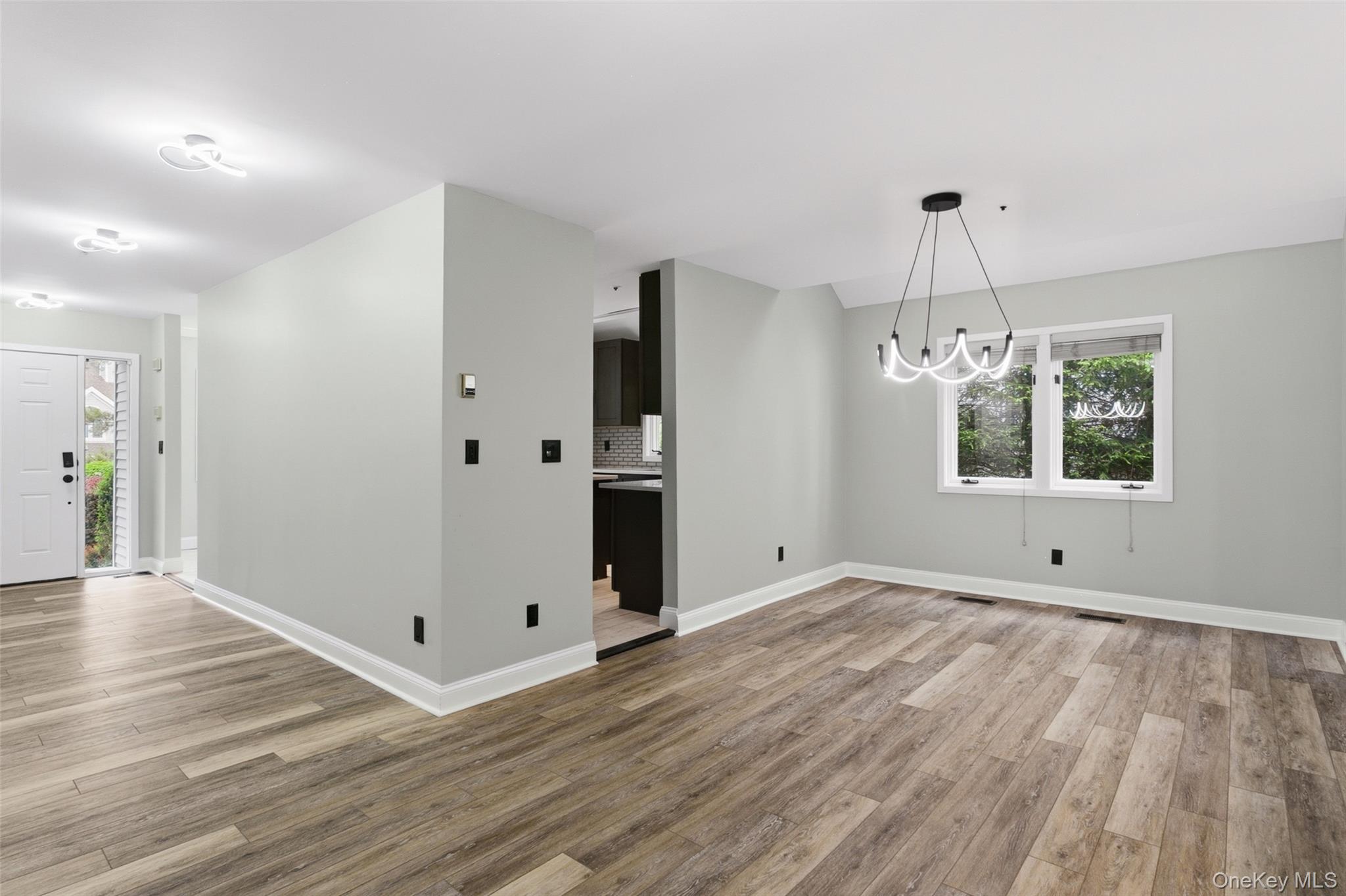 135 Boulder Ridge Road, Unit E87 Scarsdale, NY 10583 - Photo 16 of 47 an empty room with wooden floor and windows
