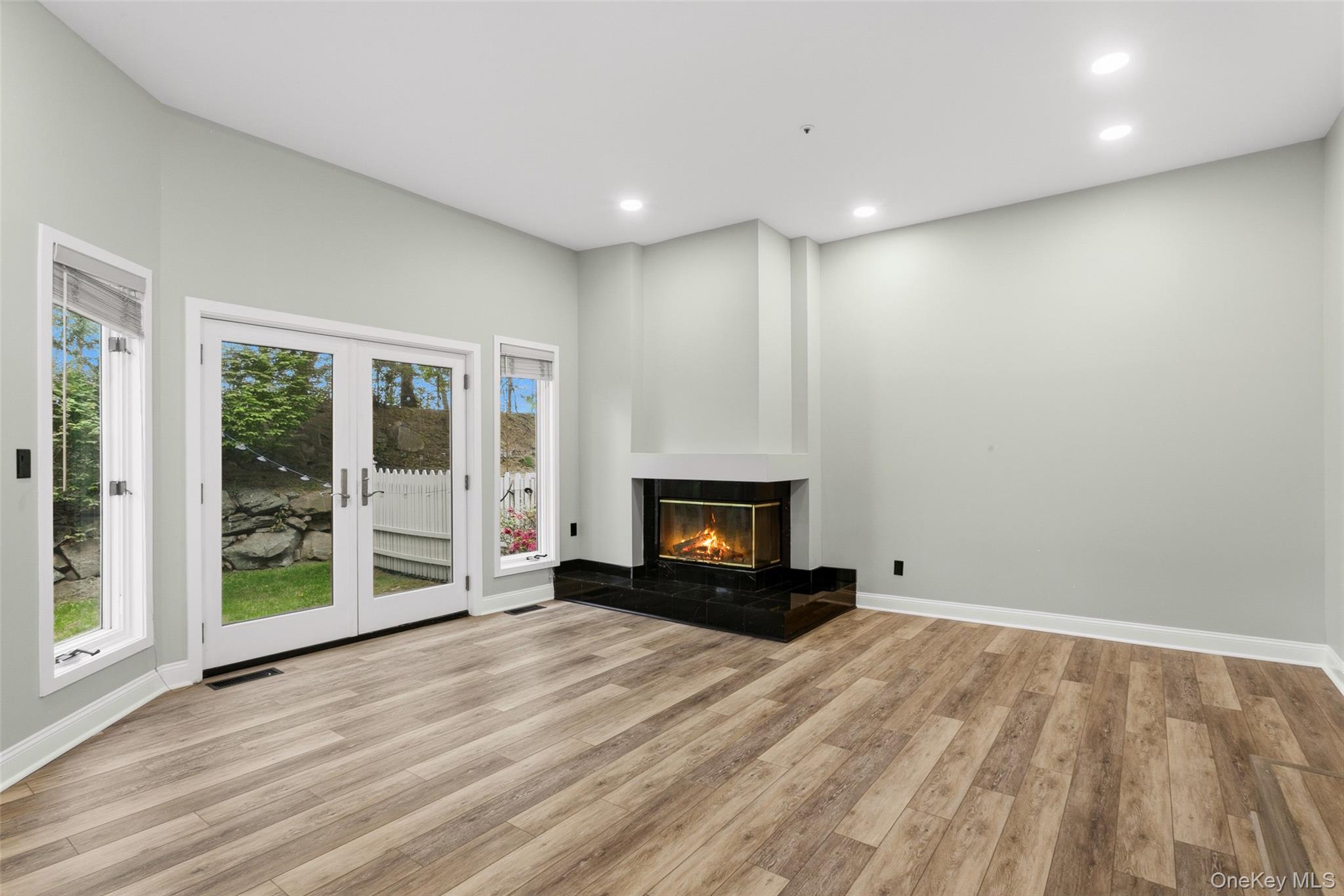 135 Boulder Ridge Road, Unit E87 Scarsdale, NY 10583 - Photo 20 of 47 a view of empty room with wooden floor and fireplace