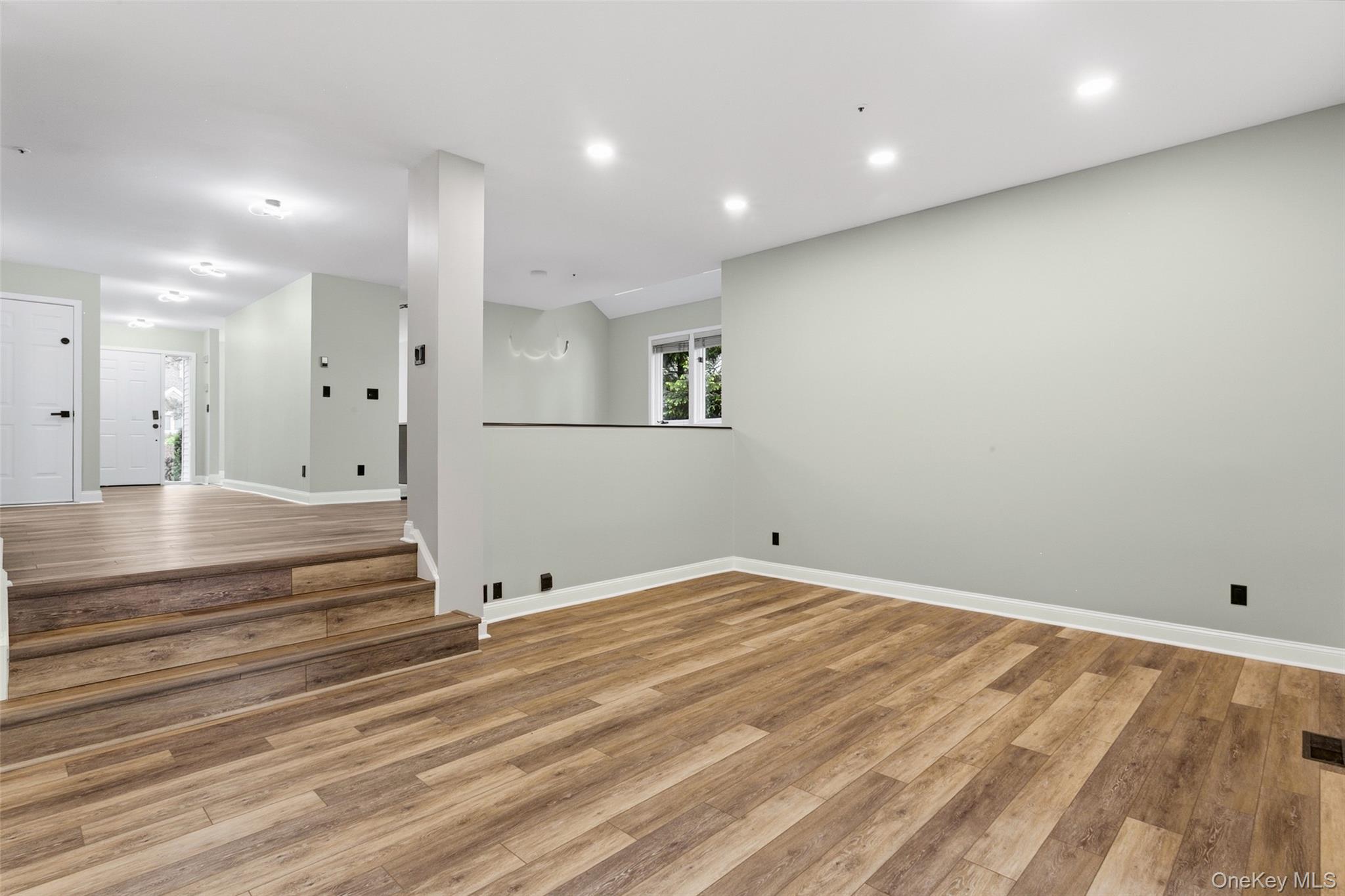 135 Boulder Ridge Road, Unit E87 Scarsdale, NY 10583 - Photo 21 of 47 an empty room with wooden floor and white walls
