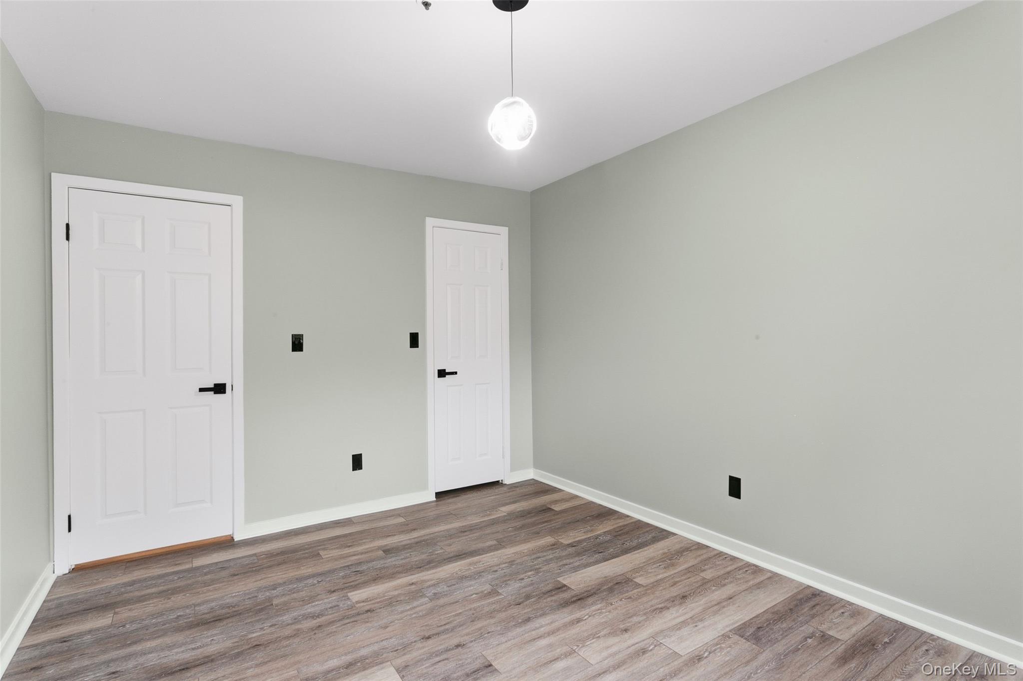 135 Boulder Ridge Road, Unit E87 Scarsdale, NY 10583 - Photo 23 of 47 a view of a room with wooden floor and white walls