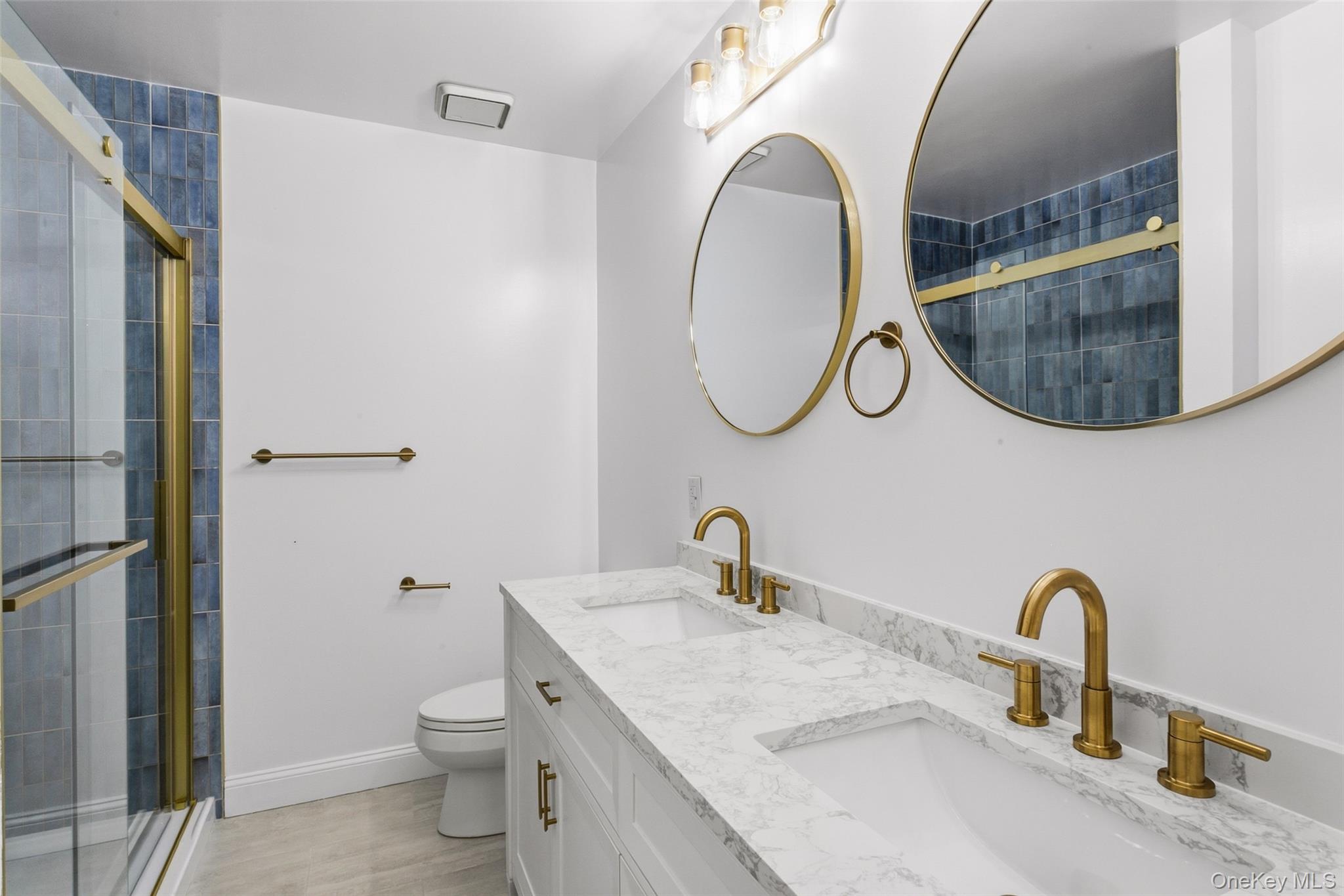 135 Boulder Ridge Road, Unit E87 Scarsdale, NY 10583 - Photo 26 of 47 a bathroom with a toilet sink and mirror