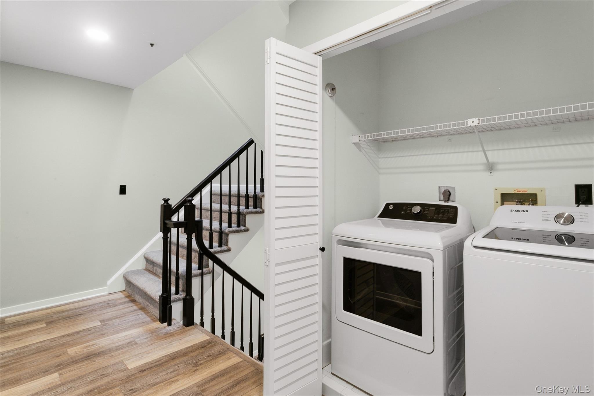 135 Boulder Ridge Road, Unit E87 Scarsdale, NY 10583 - Photo 29 of 47 a view of washer and dryer with wooden floor