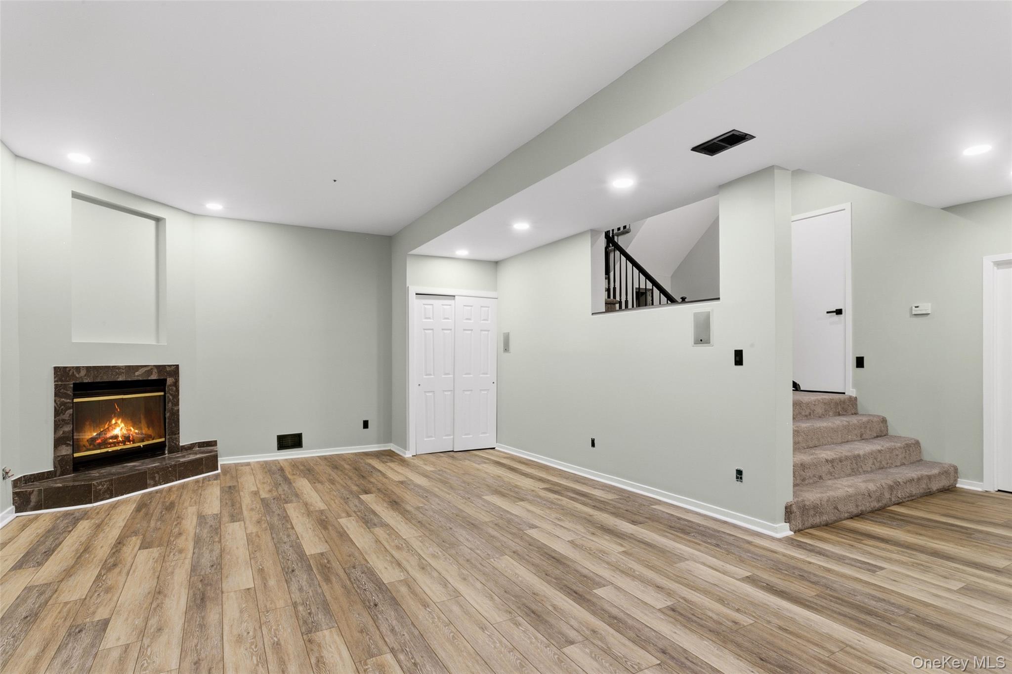 135 Boulder Ridge Road, Unit E87 Scarsdale, NY 10583 - Photo 38 of 47 a view of an empty room with wooden floor and a fireplace