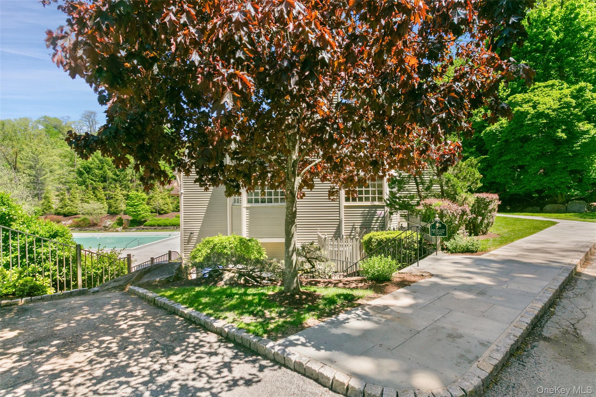 135 Boulder Ridge Road, Unit E87 Scarsdale, NY 10583 - Photo 45 of 47 a front view of a house with garden