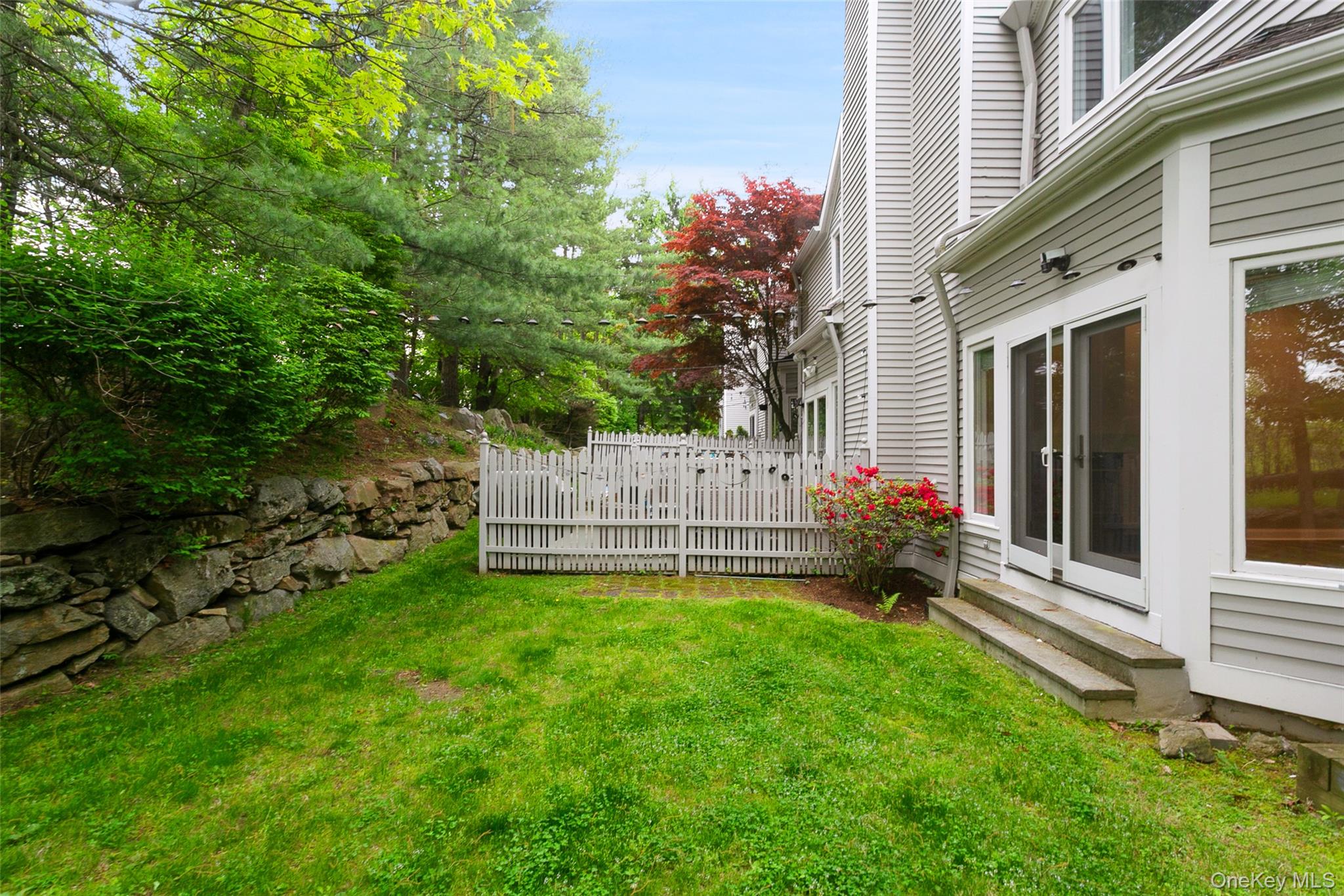 135 Boulder Ridge Road, Unit E87 Scarsdale, NY 10583 - Photo 5 of 47 a view of a house with a yard and deck