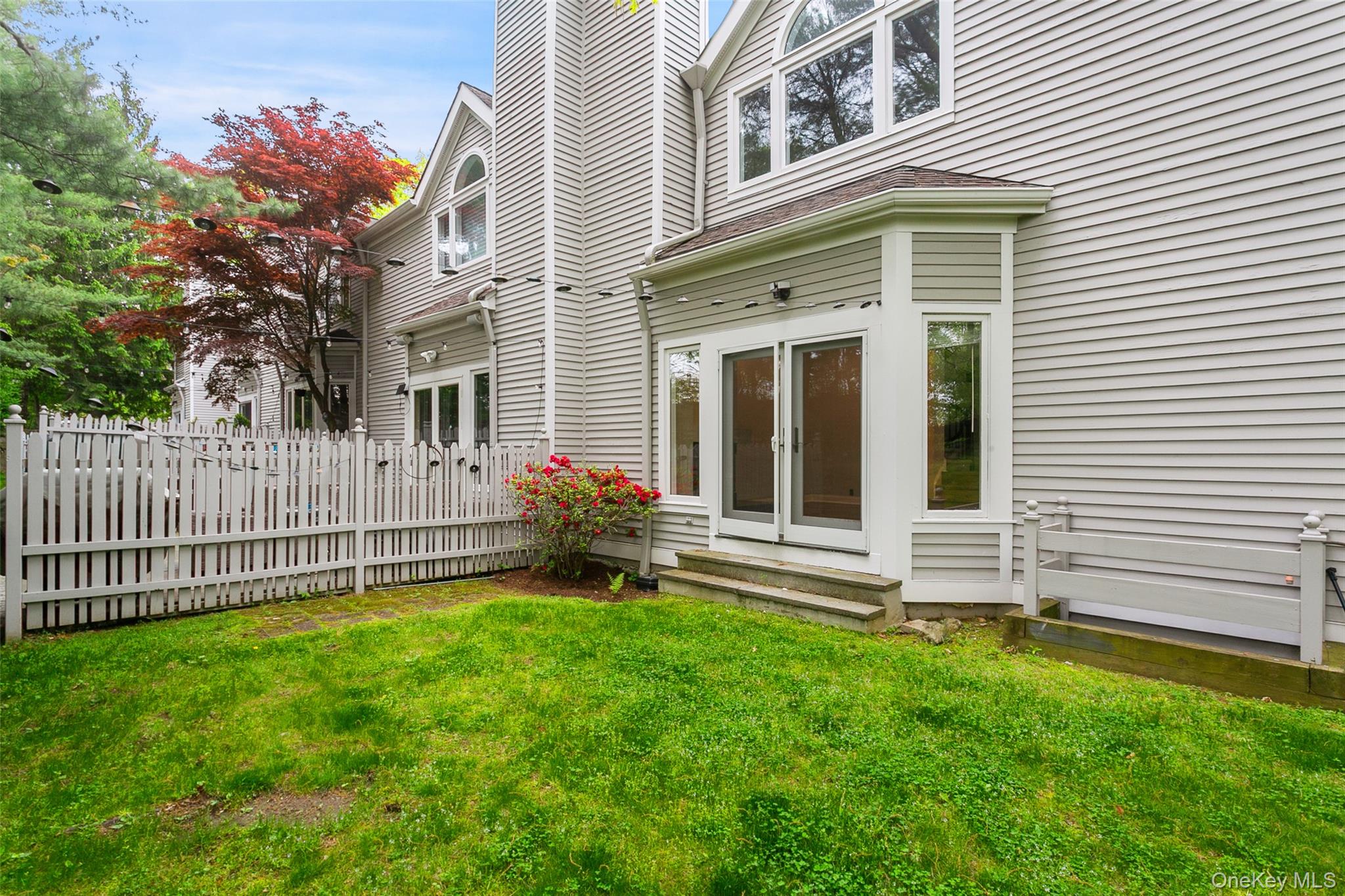 135 Boulder Ridge Road, Unit E87 Scarsdale, NY 10583 - Photo 6 of 47 a view of a house with a yard and a garden