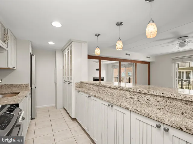 a view of a kitchen with a sink and windows