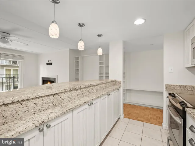 a bathroom with a granite countertop double vanity sink and a mirror