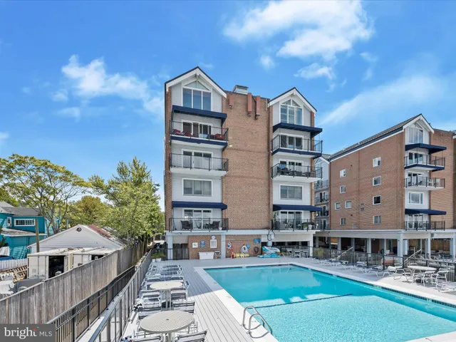 a view of a building with a yard in front of it