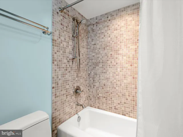 a bathroom with a bathtub and shower