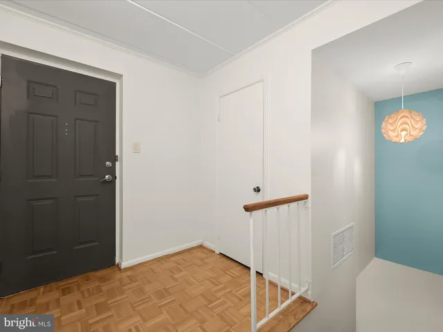 a view of hallway with stairs and a bathroom