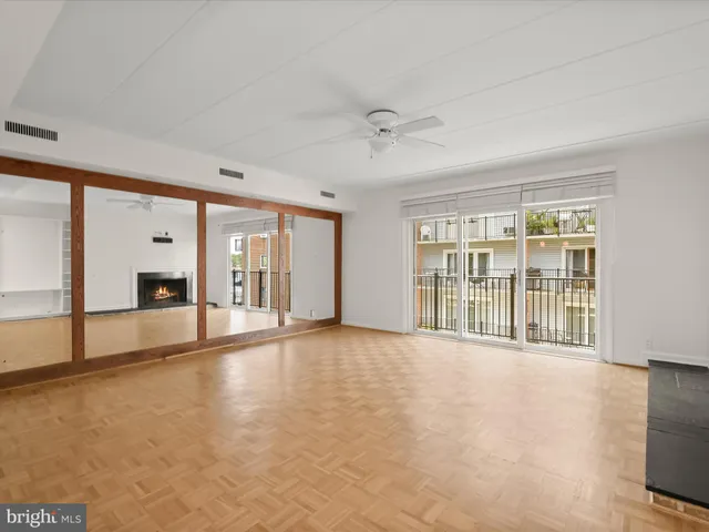 a view of an empty room with a fireplace and a large window