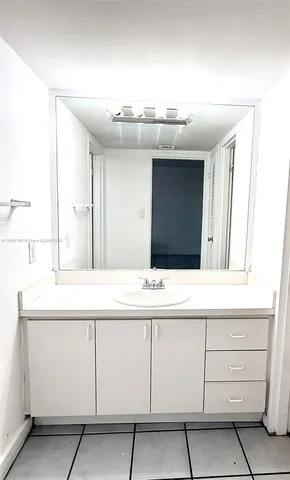 a bathroom with a sink vanity and mirror