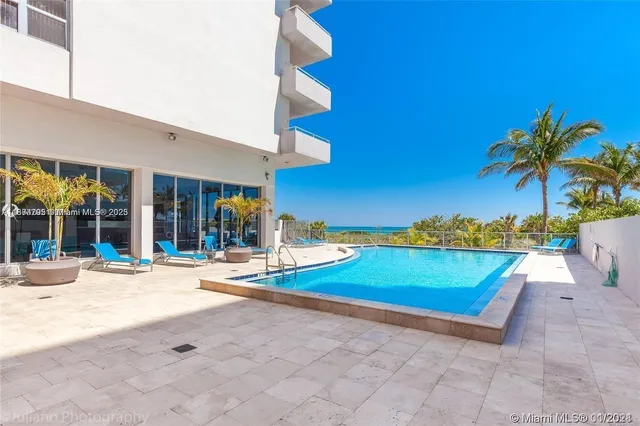 a view of a house with swimming pool and porch with furniture