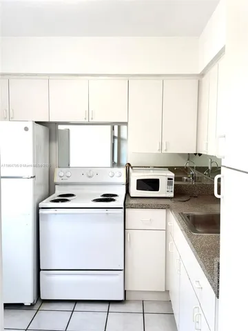a kitchen with appliances cabinets and a sink