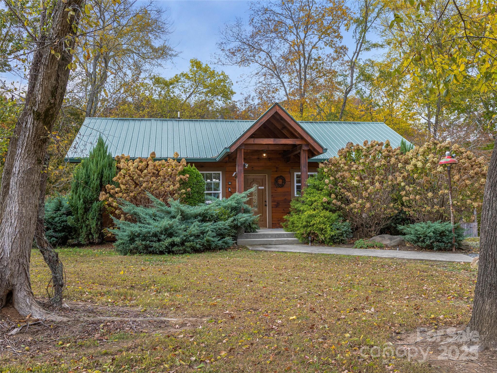 1640-1641 River Road Hot Springs, NC 28743 - Photo 5 of 48 a front view of a house with garden