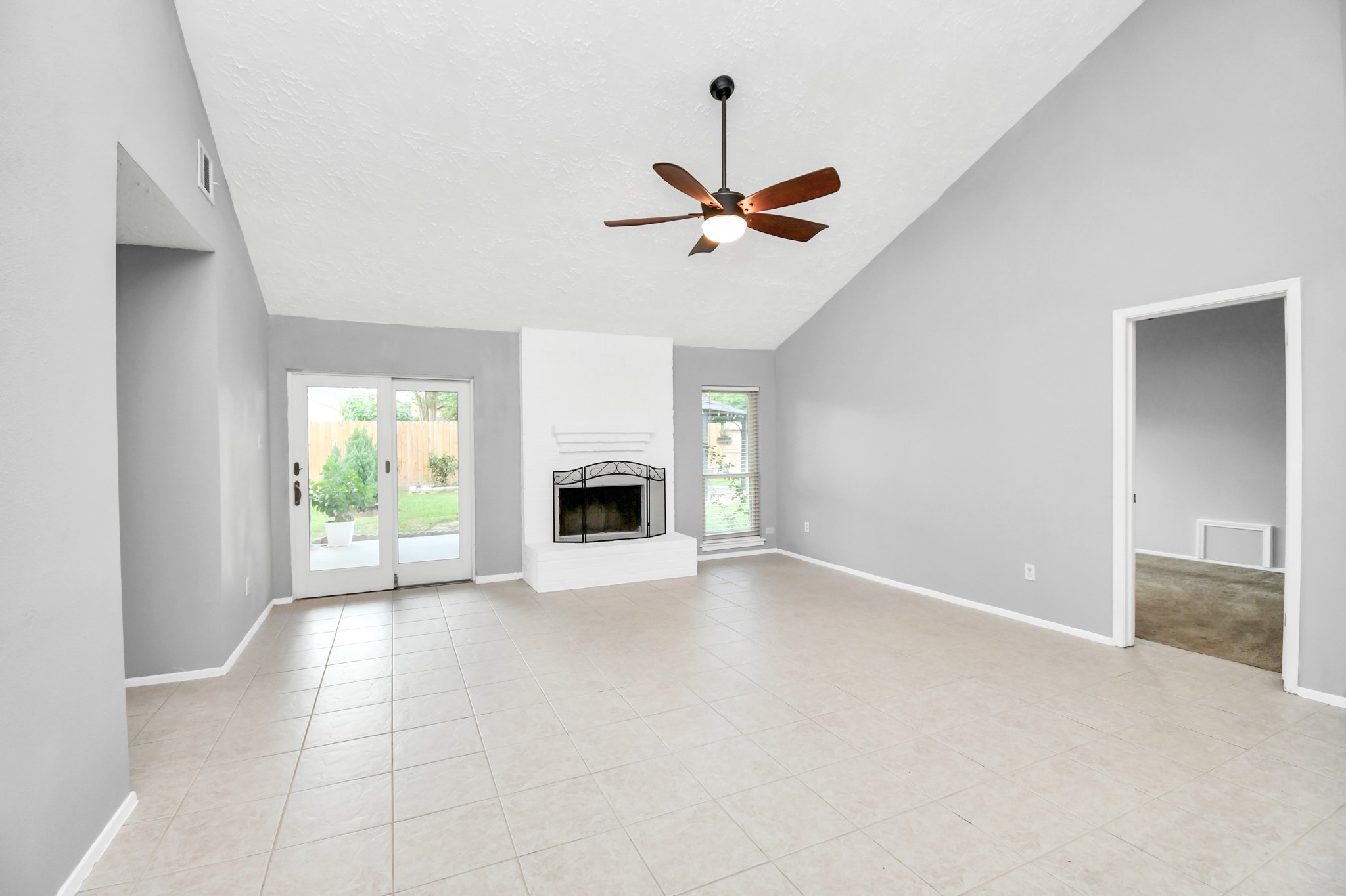 10219 Trading Post Drive Houston, TX 77064 - Photo 11 of 39 an empty room with windows and fireplace