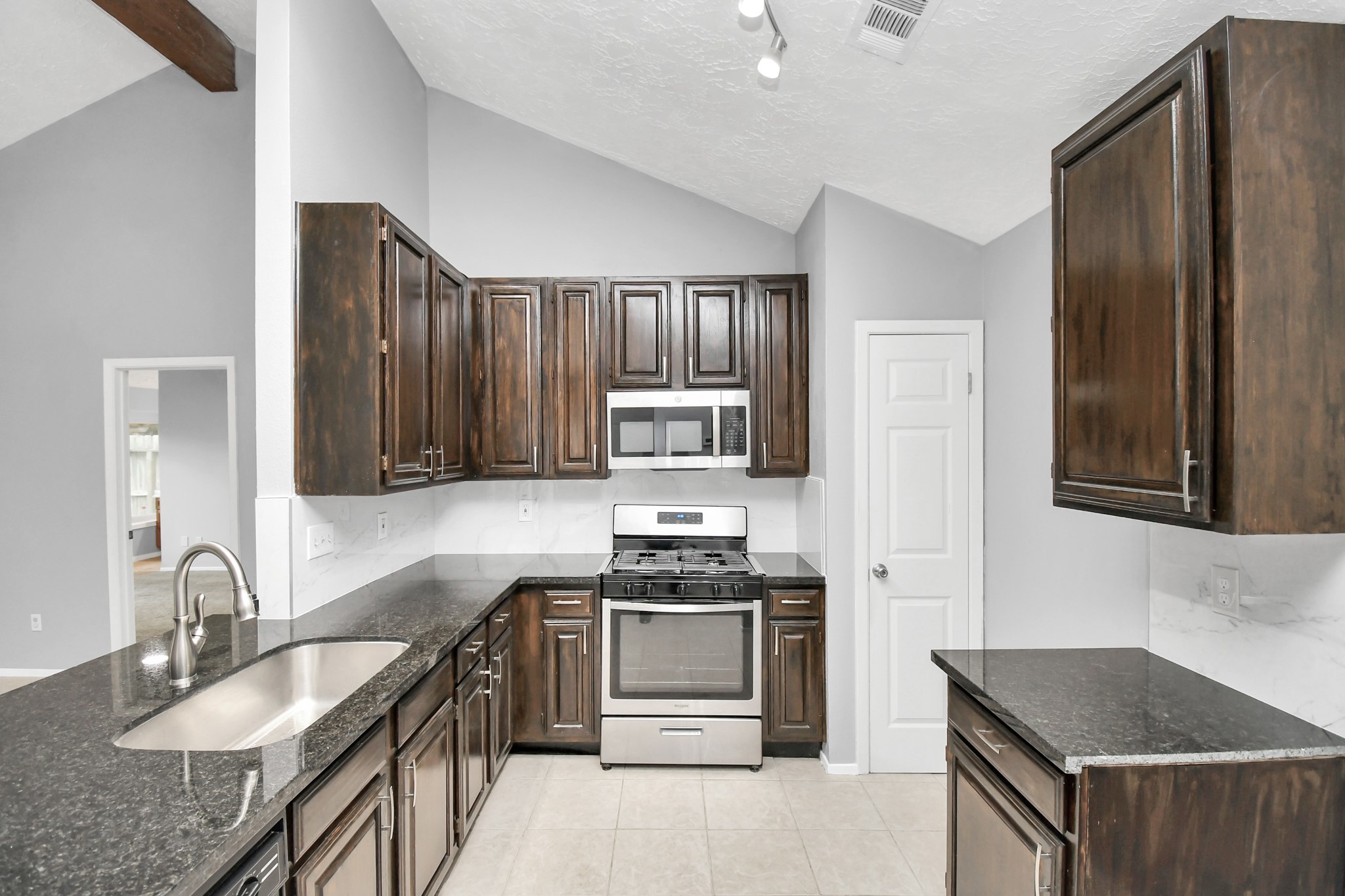 10219 Trading Post Drive Houston, TX 77064 - Photo 14 of 39 a kitchen with granite countertop a stove sink and refrigerator