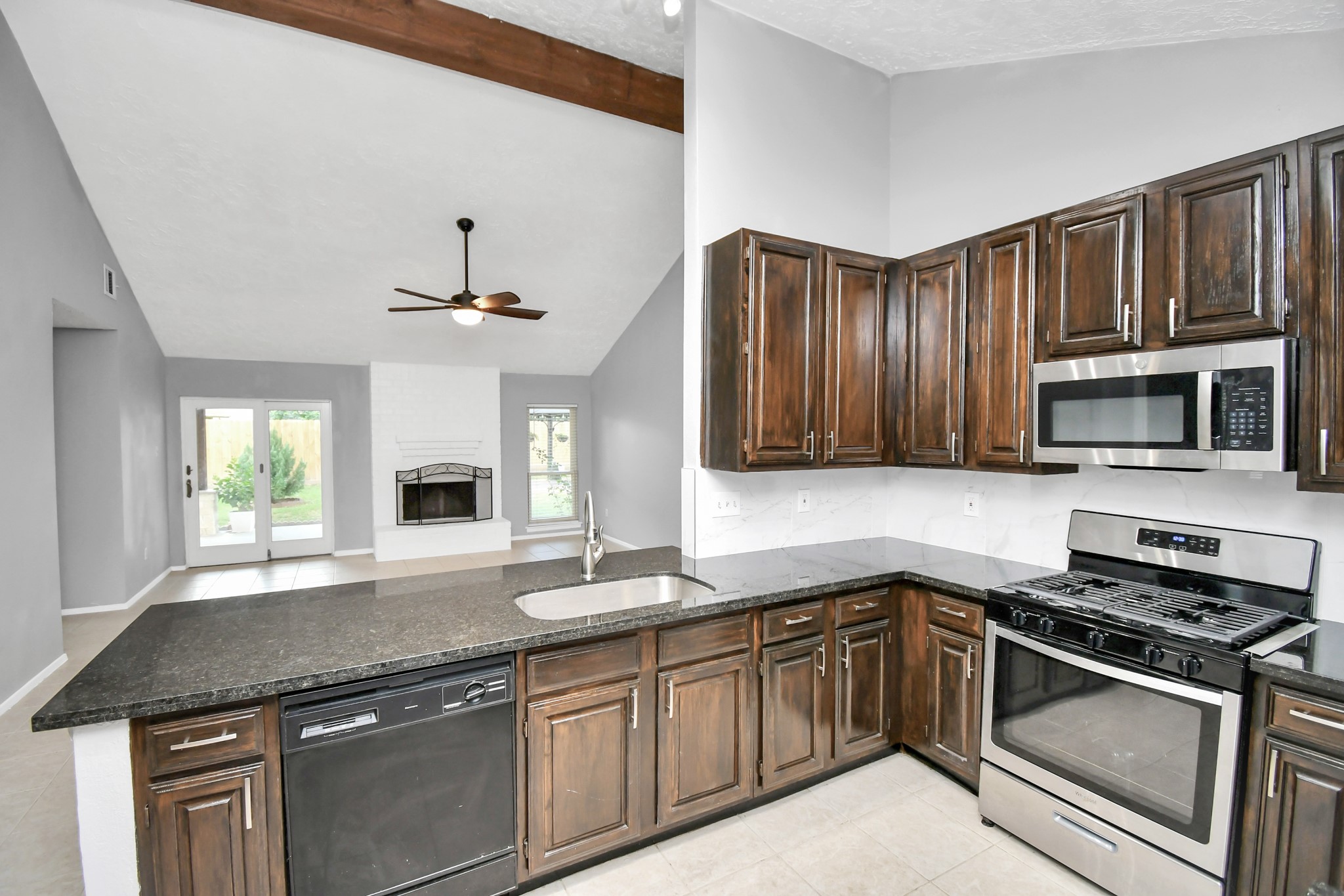 10219 Trading Post Drive Houston, TX 77064 - Photo 16 of 39 a kitchen with granite countertop stainless steel appliances a stove sink and cabinets