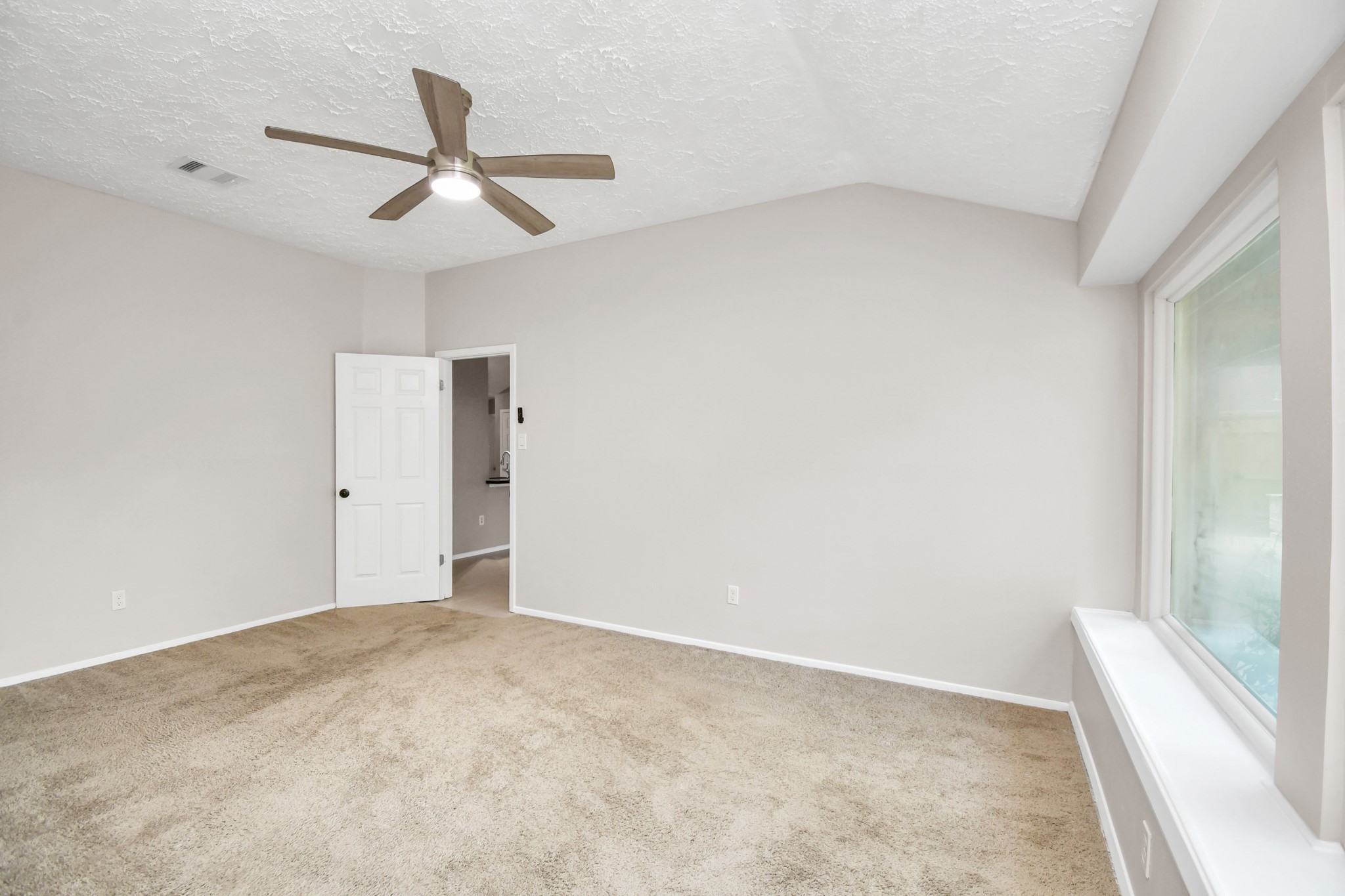 10219 Trading Post Drive Houston, TX 77064 - Photo 21 of 39 an empty room with a ceiling fan and window