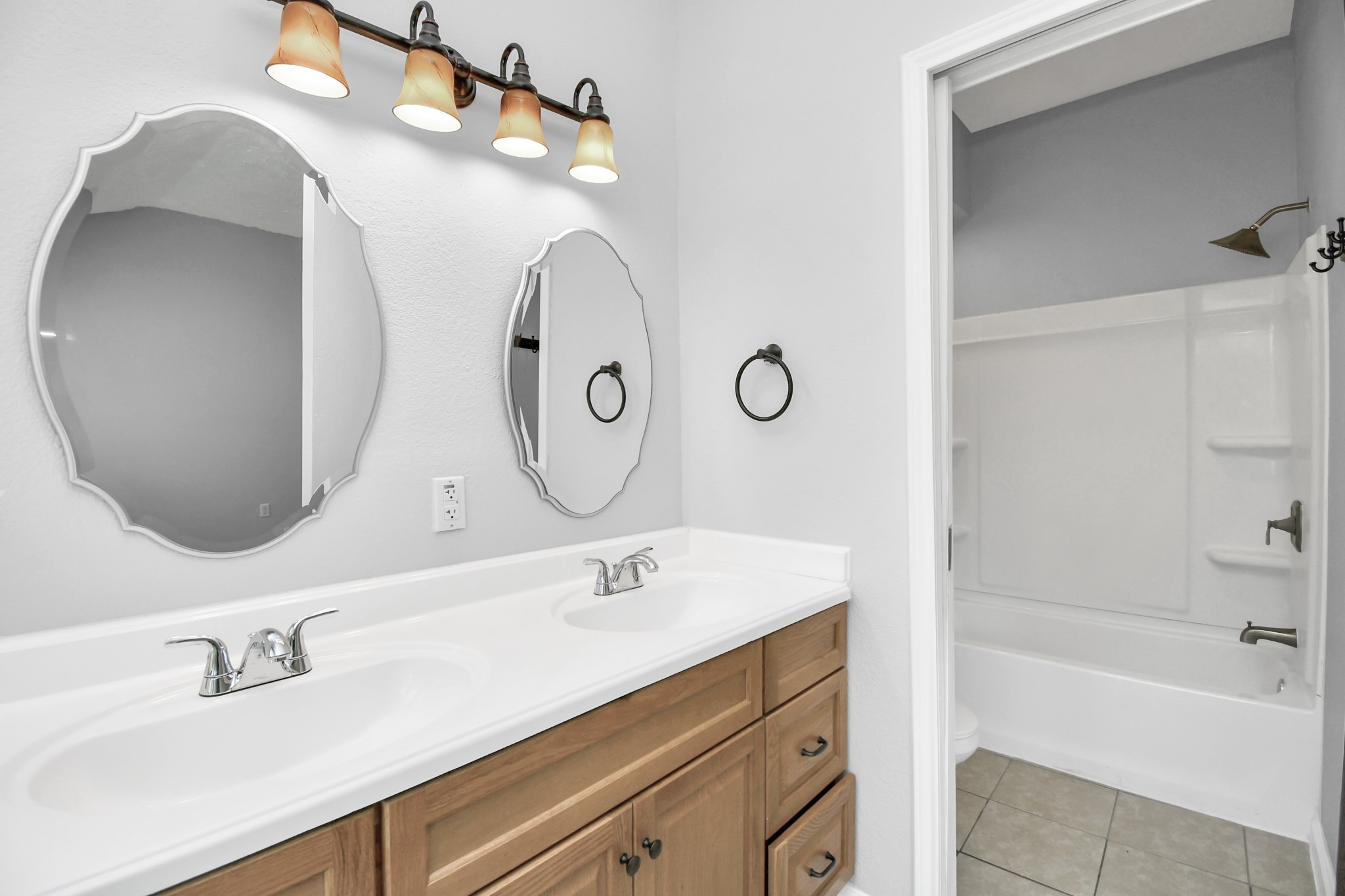 10219 Trading Post Drive Houston, TX 77064 - Photo 23 of 39 a bathroom with a double vanity sink mirror and bathtub