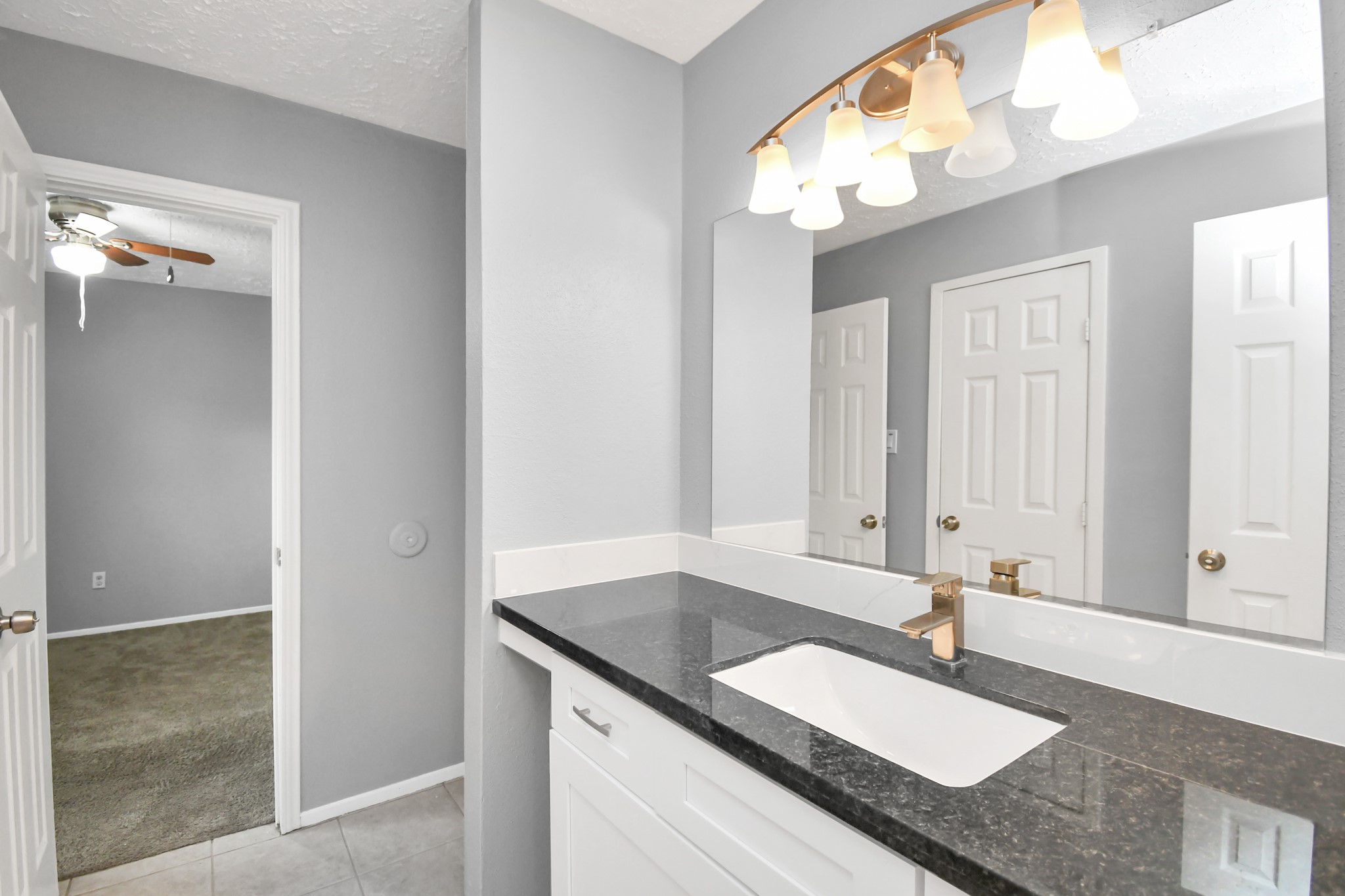10219 Trading Post Drive Houston, TX 77064 - Photo 26 of 39 a bathroom with a granite countertop sink and a mirror