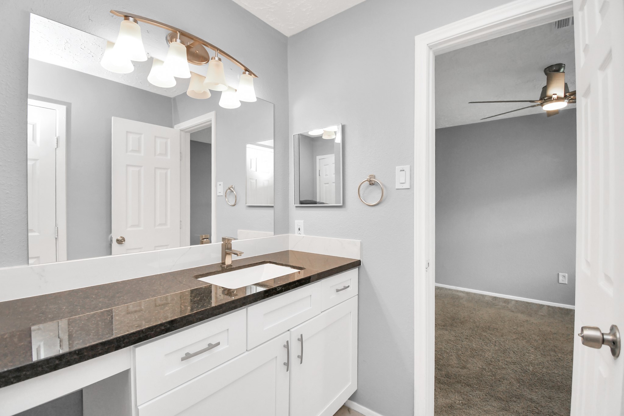 10219 Trading Post Drive Houston, TX 77064 - Photo 28 of 39 a bathroom with a granite countertop sink and a mirror