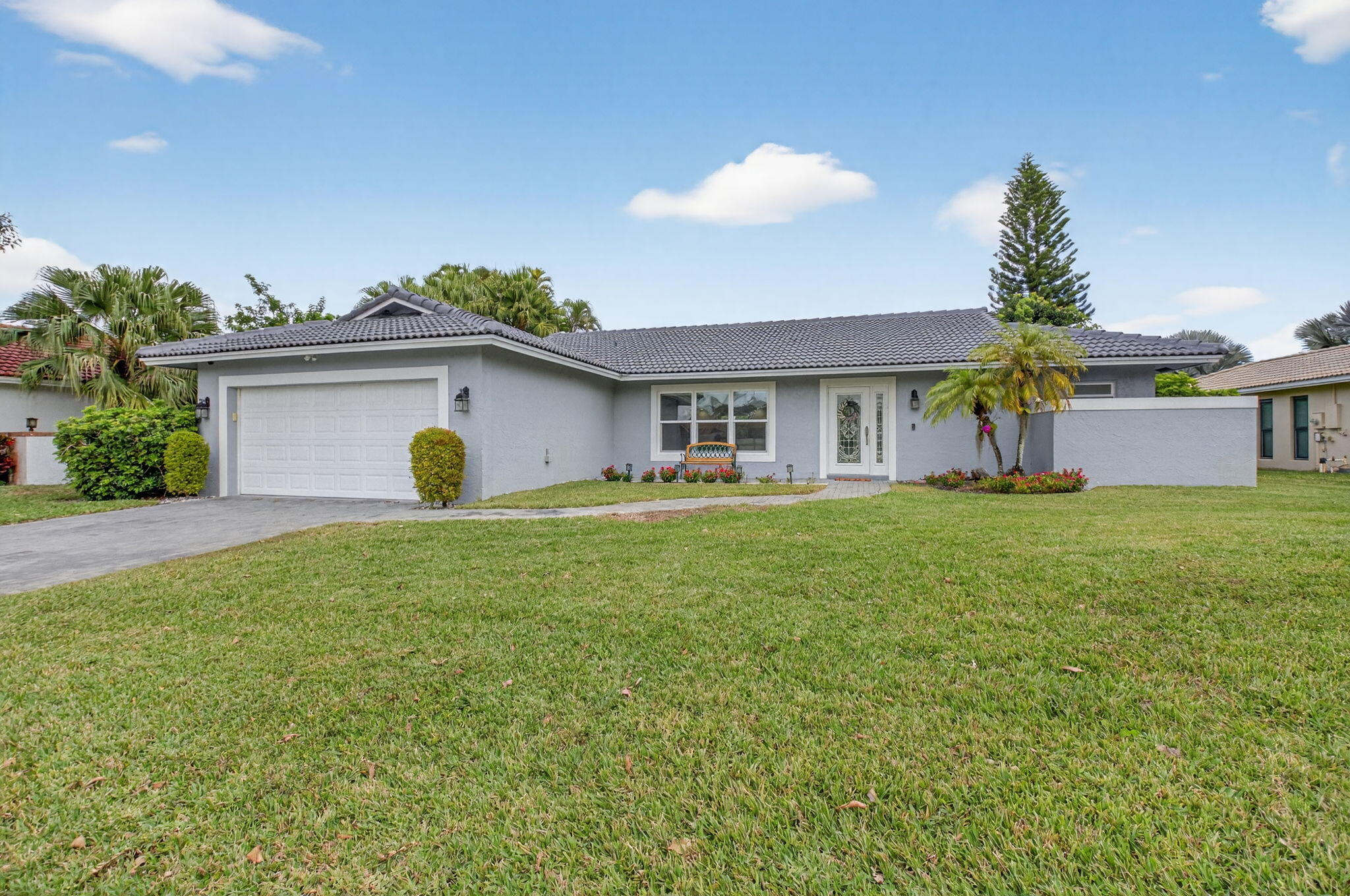 10302 Crosswind Road Boca Raton, FL 33498 - Photo 1 of 27 a house view with a garden space