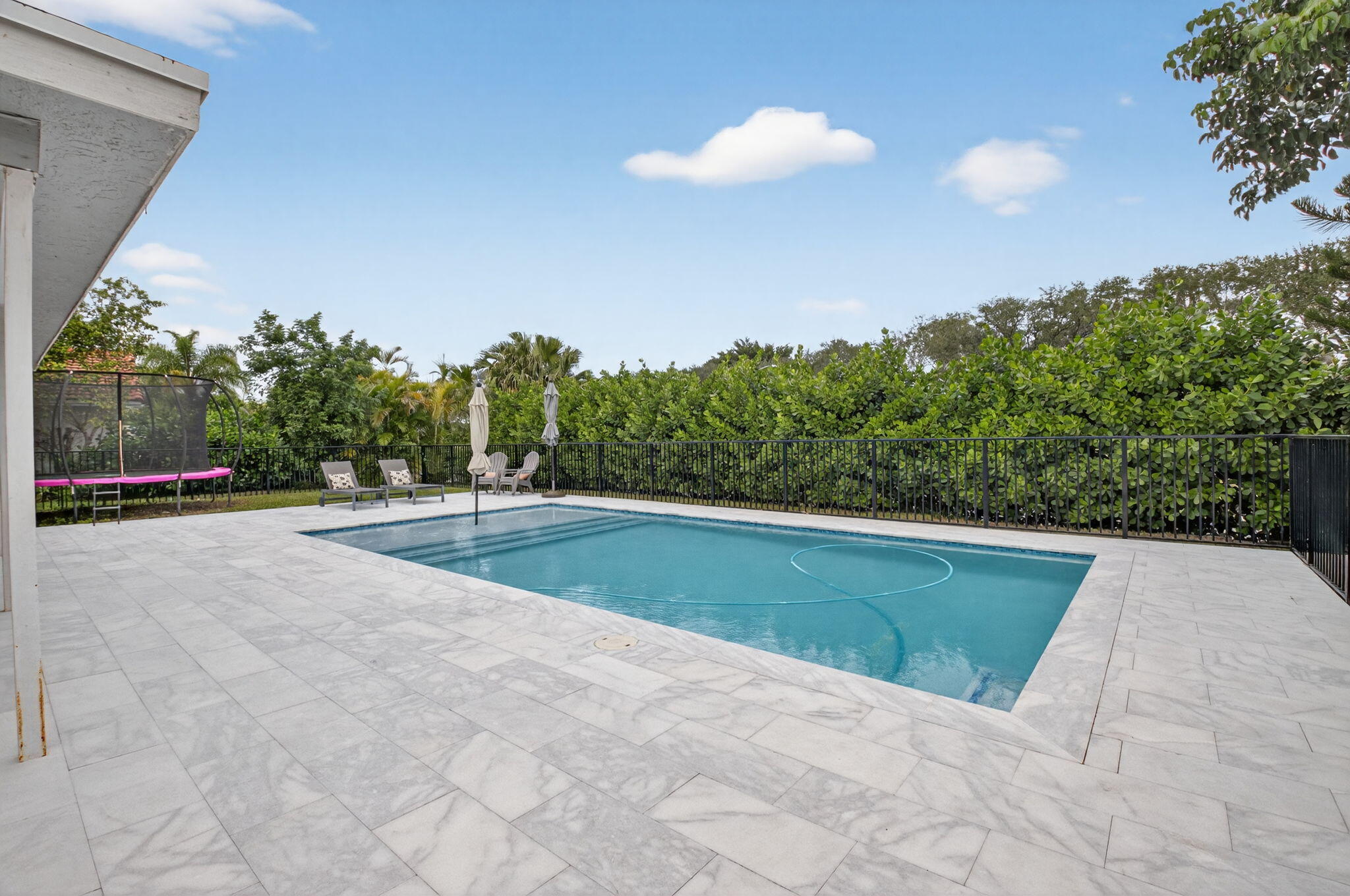 10302 Crosswind Road Boca Raton, FL 33498 - Photo 11 of 27 a view of swimming pool with a yard and plants