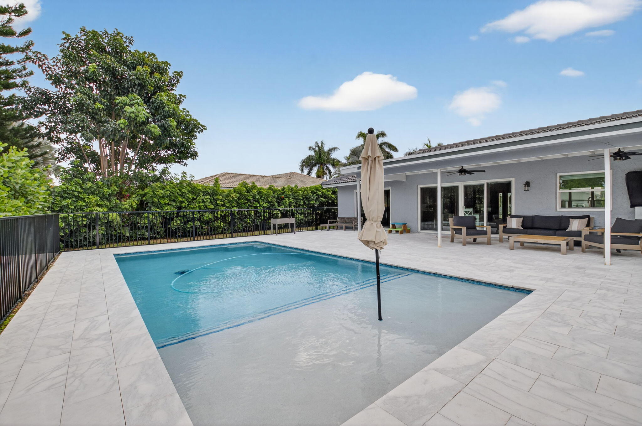 10302 Crosswind Road Boca Raton, FL 33498 - Photo 12 of 27 a view of a swimming pool with outdoor seating