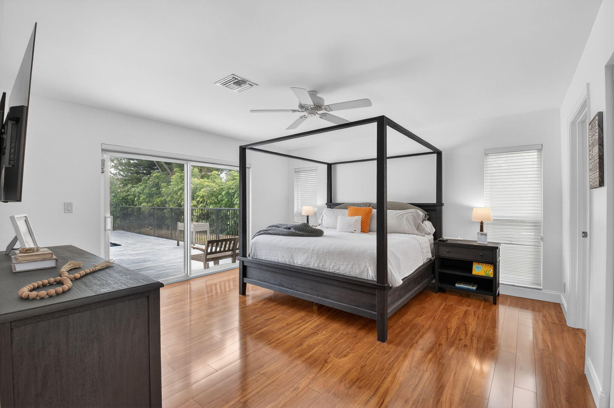 10302 Crosswind Road Boca Raton, FL 33498 - Photo 16 of 27 a bedroom with a bed window and wooden floor