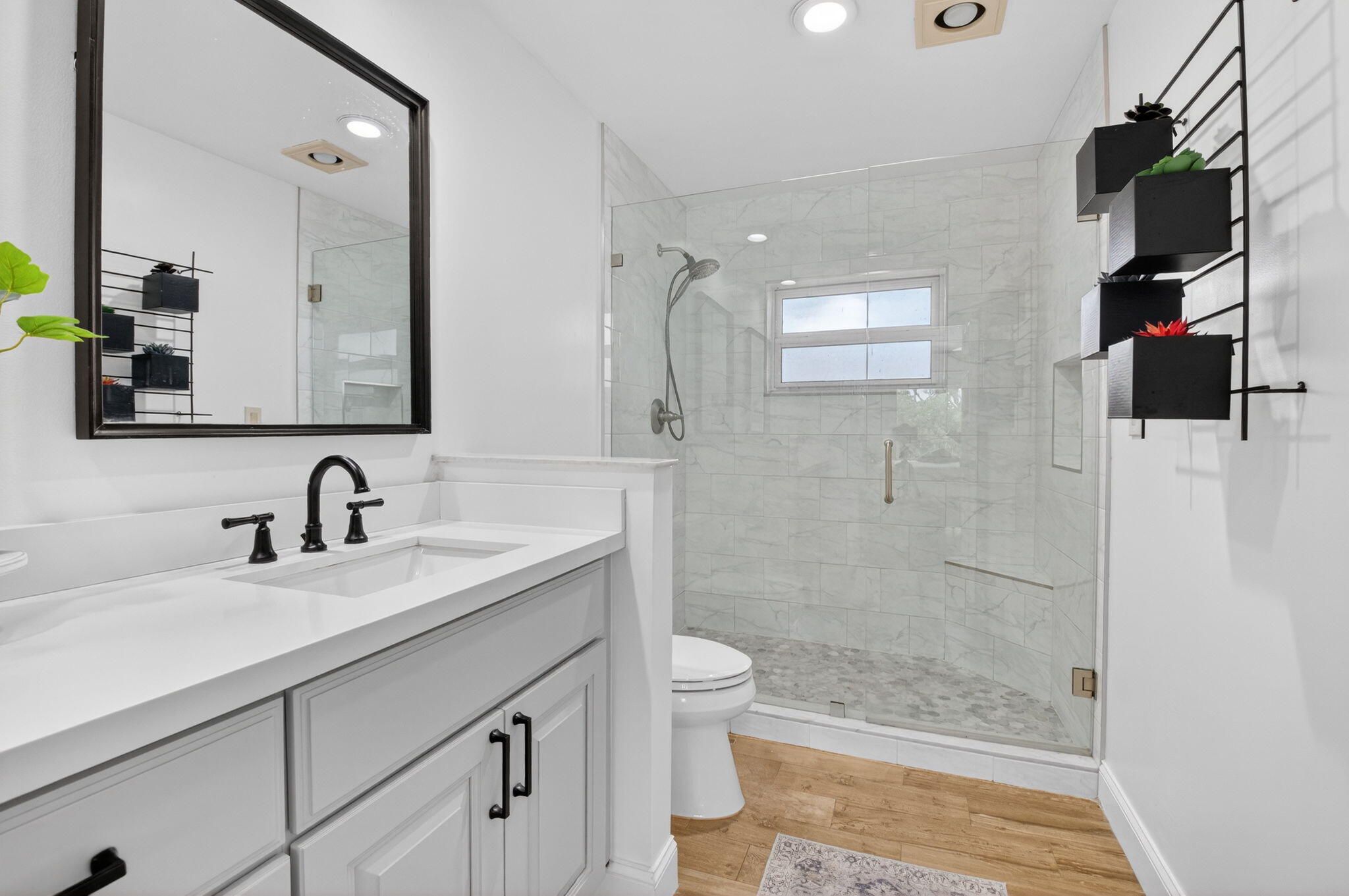10302 Crosswind Road Boca Raton, FL 33498 - Photo 19 of 27 a bathroom with a granite countertop sink a toilet a mirror and shower