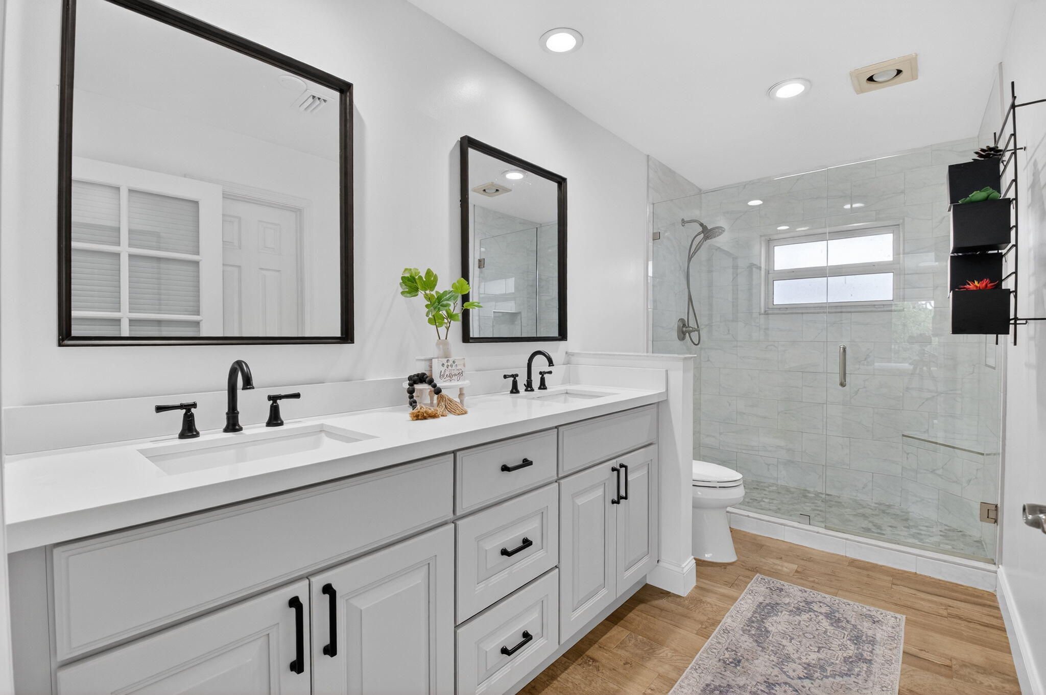 10302 Crosswind Road Boca Raton, FL 33498 - Photo 20 of 27 a bathroom with double vanity sink a mirror and a shower