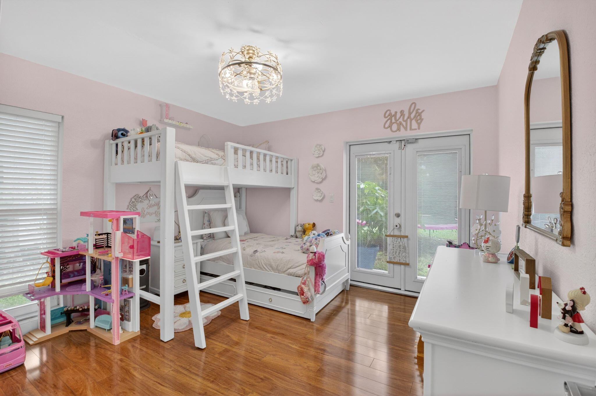 10302 Crosswind Road Boca Raton, FL 33498 - Photo 21 of 27 a bedroom with furniture and a chandelier